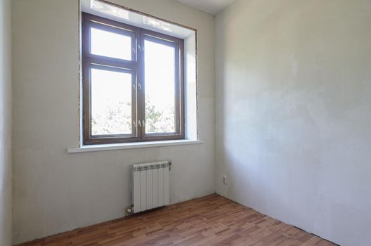 View of the window in a small room after renovation