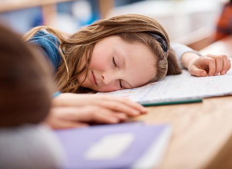 I just need to rest my brain for a bit. an elementary school girl sleeping on her desk in class.