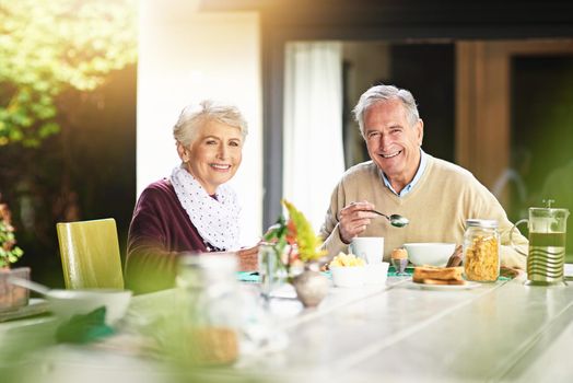 Its the best way to start your day. Portrait of a happy senior couple enjoying breakfast together at home.