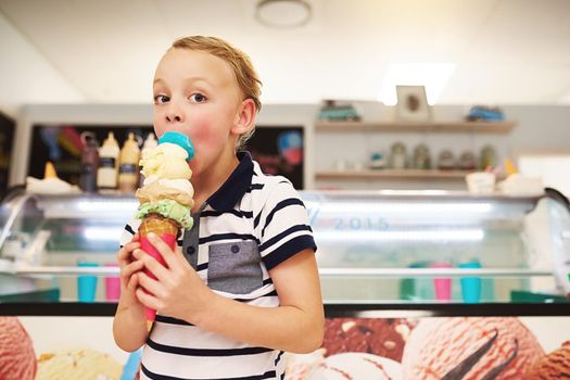 You cant buy happiness, but you can buy ice cream. Portrait of a young boy enjoying an ice cream cone.