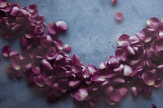 Rose petals on marble stone, floral background