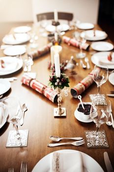 Youre invited to our Christmas feat. a place setting on a table at Christmas.