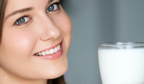 Diet and wellness, young woman with glass of milk or protein shake cocktail