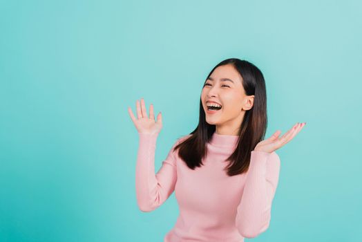 Asian beautiful woman smiling wear silicone orthodontic retainers on teeth surprised she is excited screaming and raise hand make gestures wow