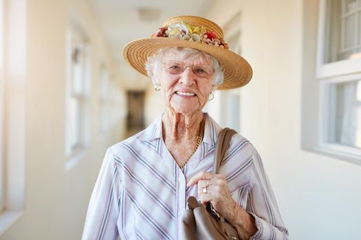 What a lovely day to go out. Portrait of a happy elderly woman getting ready to go out.