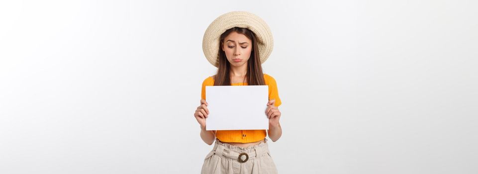 Young caucasian woman holding blank paper sheet over isolated background scared in shock with a surprise face, afraid and excited.
