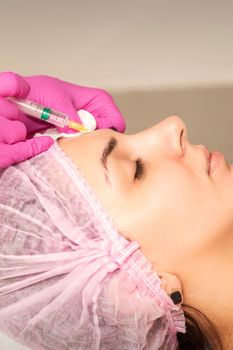 Woman receiving injection of botox