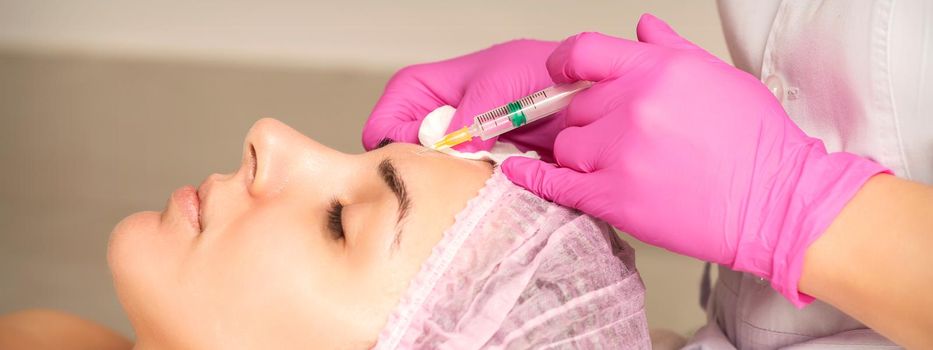 Woman receiving injection of botox