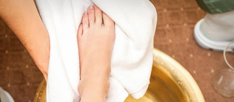 Therapist drying leg with towel