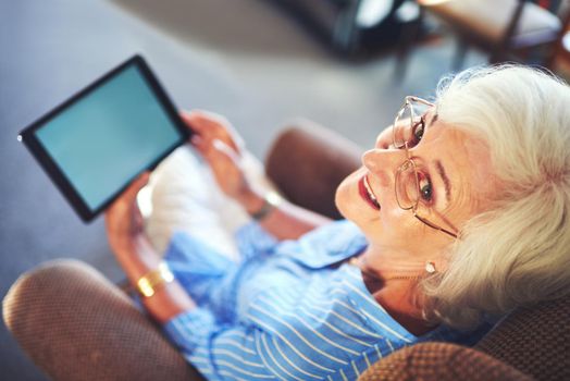 Technology made accessible for any age. a senior woman using a tablet at home.
