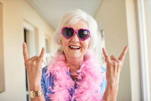 Rock on no matter the age. a senior woman at home.