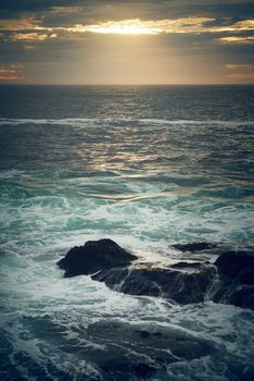 Let the sea set you free. ocean waves crashing against boulders on the seashore outdoors.