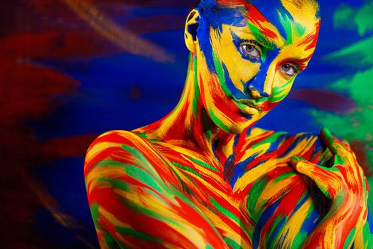 Art fashion makeup and body painting . Color face of woman for inspiration. Abstract portrait of the bright beautiful girl with colorful make-up and bodyart.