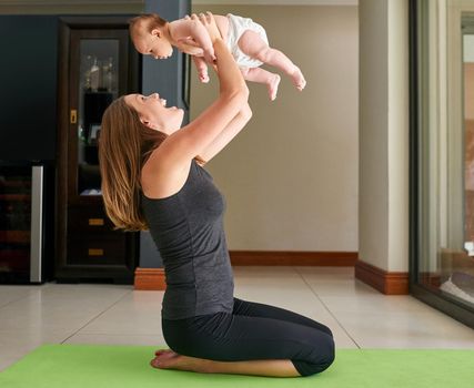 The best work out partner. a young mother and her baby at home.