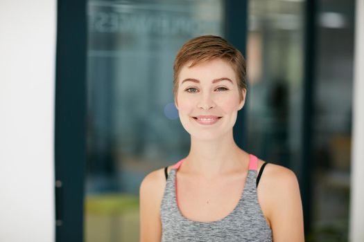 Healthy life, happy life. Portrait of a fit young woman in workout attire.