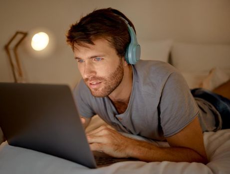 Online, laptop and late night stream or work in the bedroom. Man using internet on pc to watch series, esports or gaming to relax. Stress management and entertainment with online technology at home.