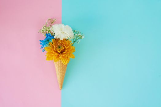Now thats something worth melting for. a cone stuffed with flowers against a colorful background.