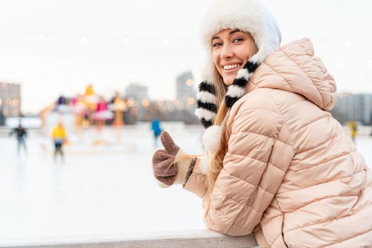 Winter woman portrait. Beautiful middle age caucasian female standing outdoor dressed funny fluffy hat looking camera smile