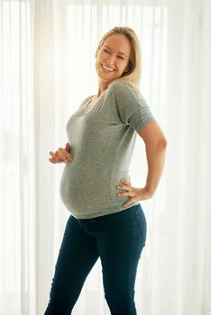 I just cant help but to be excited. a beautiful woman posing with her baby bump.