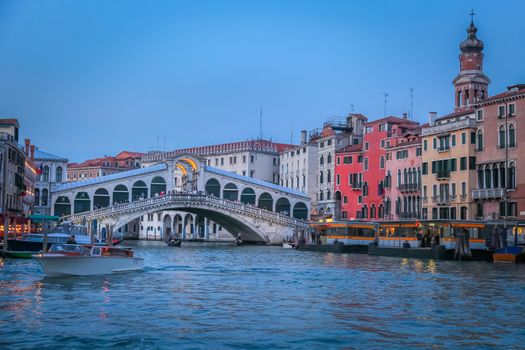 Rialto and ornate Gondolas in Grand Canal pier at sunset, Venice, Italy