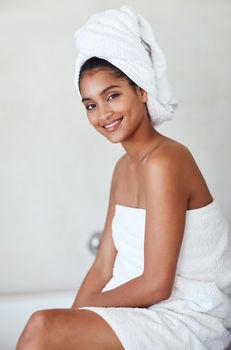 Who said you cant pamper yourself everyday. Portrait of an attractive and relaxed young woman wrapped in a towel at home.