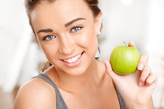 Woman eating apple for healthy, fresh and balanced diet with nutrition, fruit and vitamins. Portrait face of fitness, young and happy vegan for weightloss food, organic wellness and beauty skincare