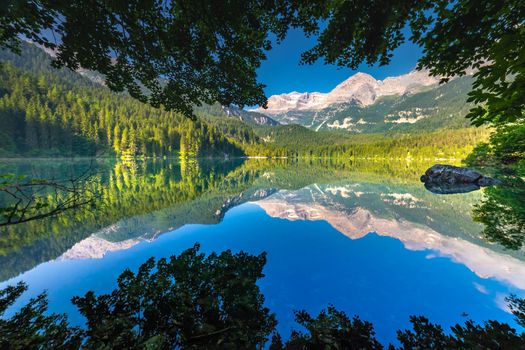 Framed Lake Tovel reflection symmetry in Trentino-Alto Adige, Dolomites, Italy