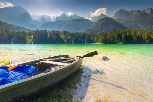 Boat anchored in Lake Tovel reflection in Trentino-Alto Adige, Dolomites, Italy