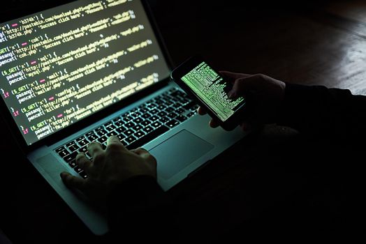 How safe are you online. an unidentifiable hacker using a laptop late at night.