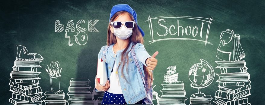 Young girl with protection mask against corona virus at school.