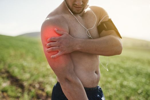 Feeling an old arm injury. an unrecognizable man exercising with an injury highlighted by cgi.