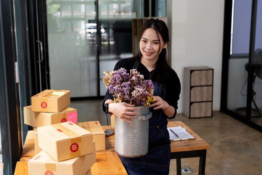 Young start up business woman asian working as SME entrepreneur new business with packaging box, flower shop
