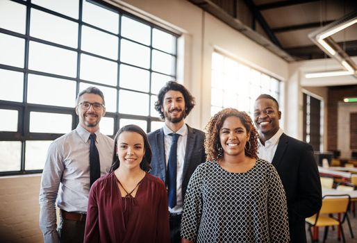 Were the only team you need. Cropped portrait of a diverse team of happy businesspeople posing together in their office.