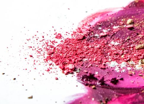 Artistic lipstick smudge and crushed eyeshadow as background