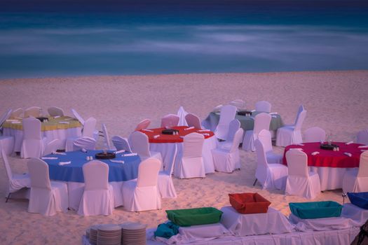 Cancun caribbean beach, chairs and tables at evening, Riviera Maya, Mexico