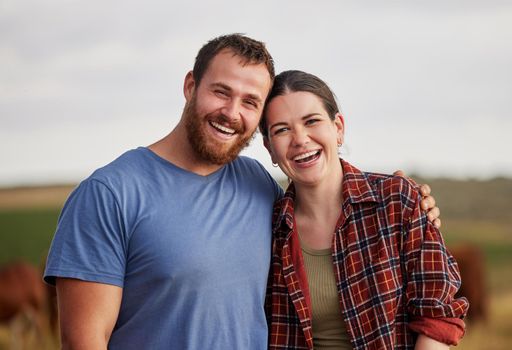 Happy, carefree, and excited farmer couple standing outdoors on cattle or livestock farmland. Portrait of relaxed lovers relaxing on organic or sustainable land smiling and enjoying nature