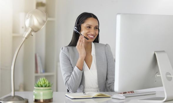 Customer service, consultant and contact support by call center agent talking to a customer on video call. Happy employee enjoying online customer care while working on guidance and advice in office