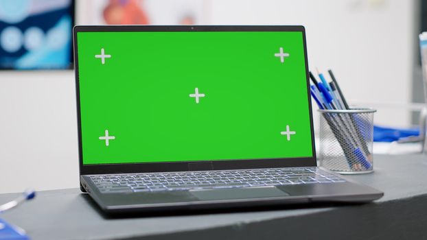 Laptop with greenscreen display on facility reception counter