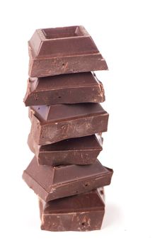 chocolate pieces. dark chocolate bars stacked high
