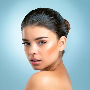 The complexion of perfection. Studio shot of an attractive young woman with a perfect complexion posing against a blue background.