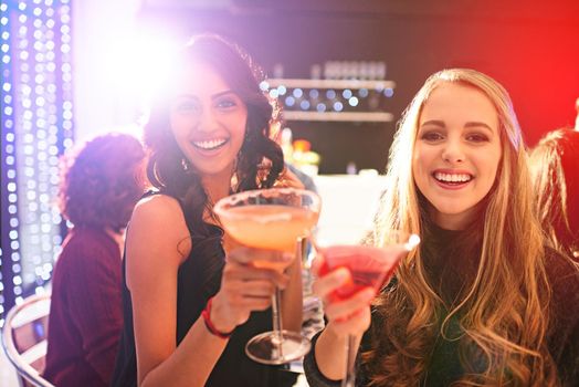 Time to celebrate. Portrait of two young women drinking cocktails at a party.