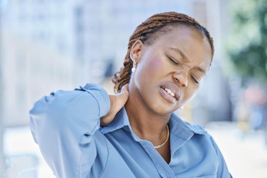 Woman manager with stress and pain in her neck while standing outside the office building. Female business leader at work with aching muscle in need of a wellness massage or a medical doctor for help