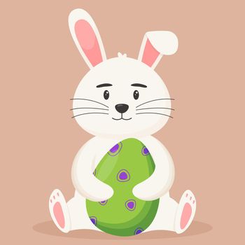 Cute Easter bunny with an Easter egg in its paws. Easter concept