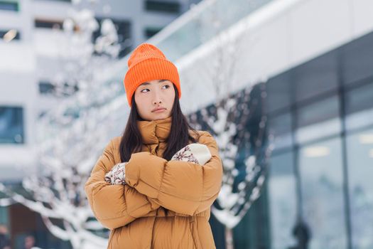 Beautiful asian woman waiting for a partner, dating after online dating, cold winter day with snow