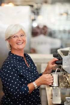 Youre never too old to do what you love. Portrait of a senior woman working in a coffee shop.