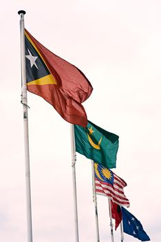 Flying in a single line. Flags of East Timor, Mauritania, Russia and the Federated States of Micronesia blowing in the wind.