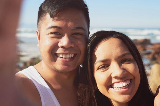 We want to remember this moment. Selfie of a happy young couple by the sea together.