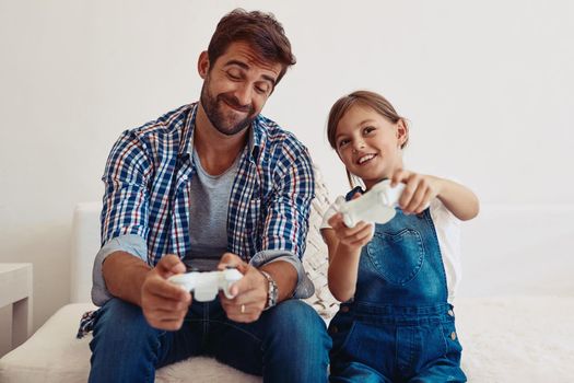 No, I gave her the one controller that works. a father and his daughter playing video games at home.