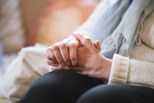 Elderly woman hands clasped retirement concept