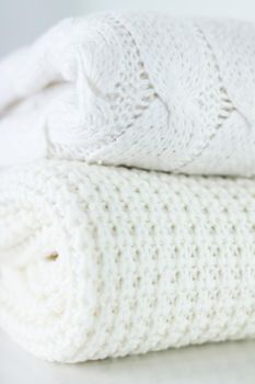 Warm knitted clothes, soft and white